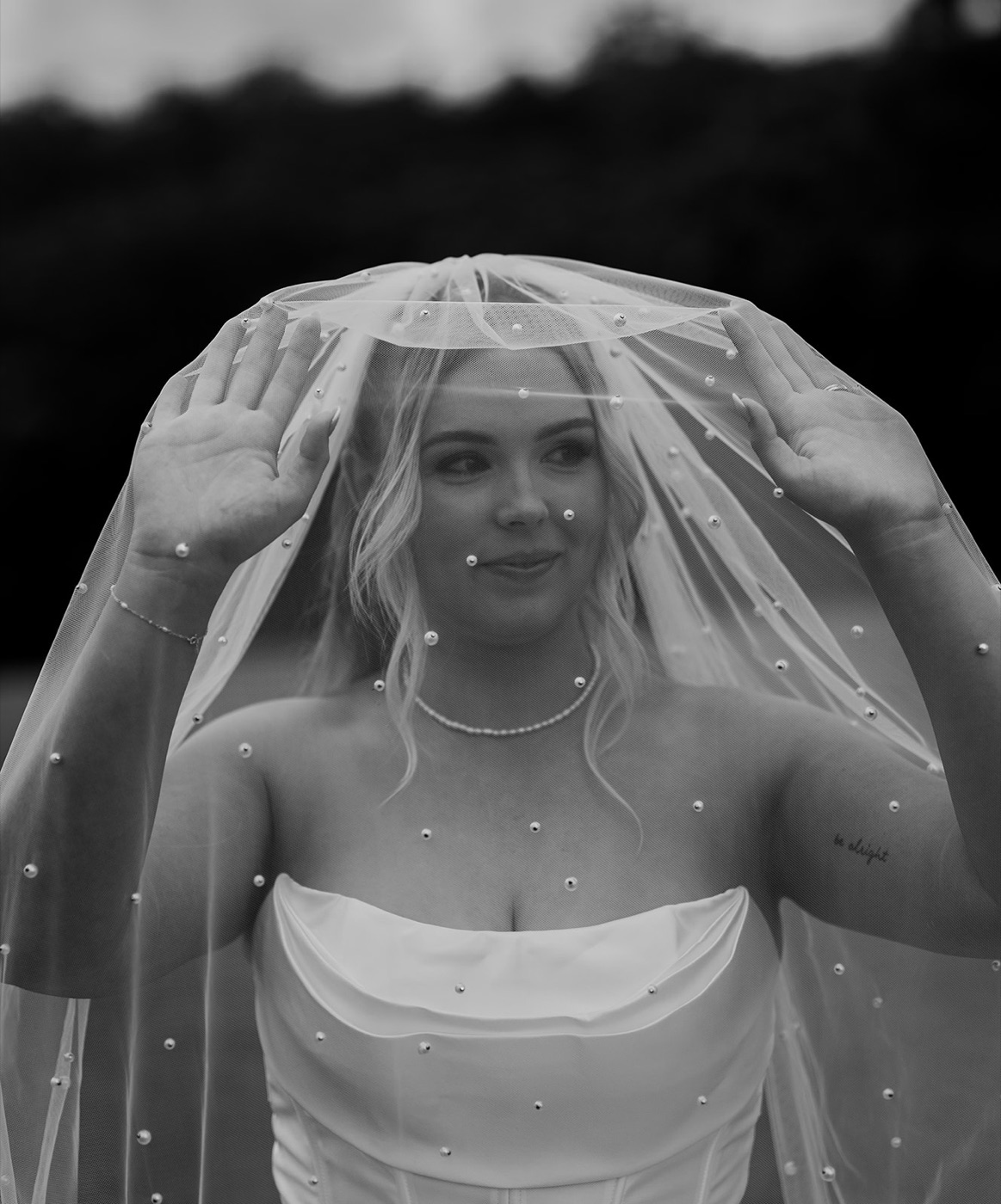 Bride beneath her veil, black and white