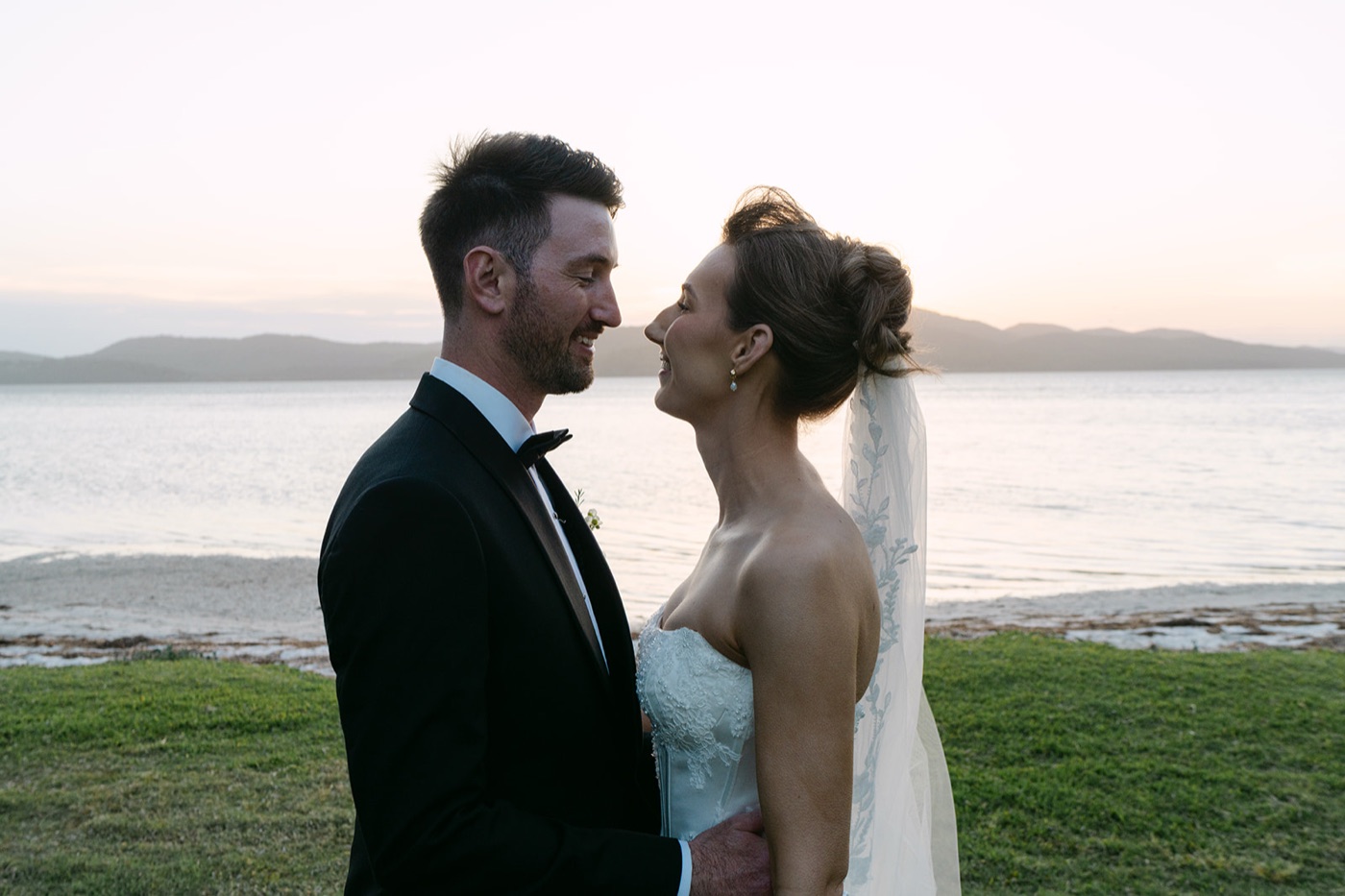 Couple at the water's edge at dusk